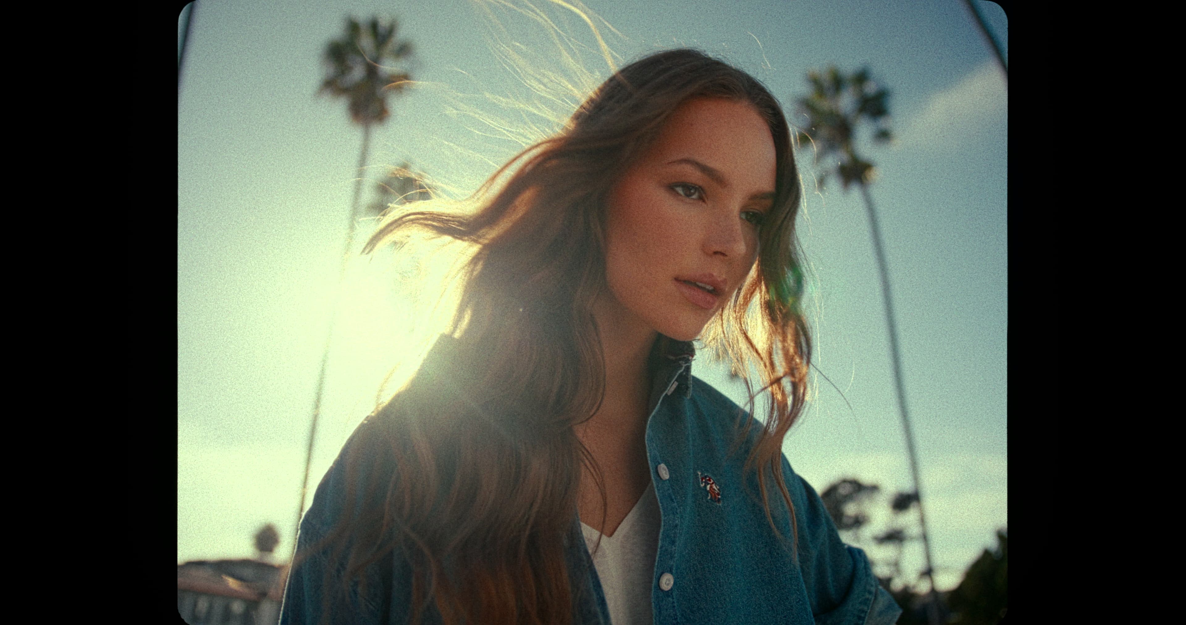 Fashion portrait with windblown hair in backlight