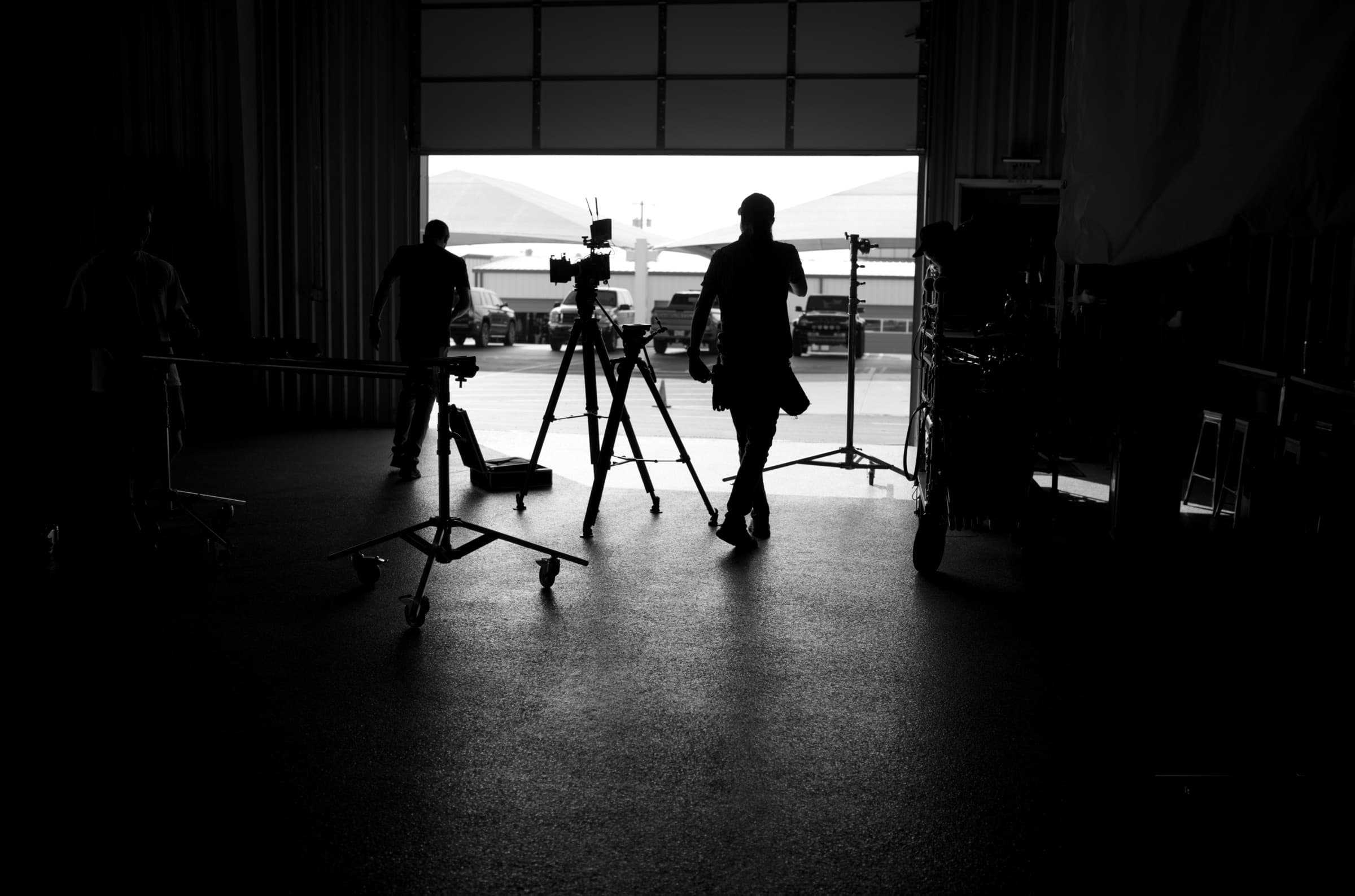 Crew silhouettes in warehouse doorway