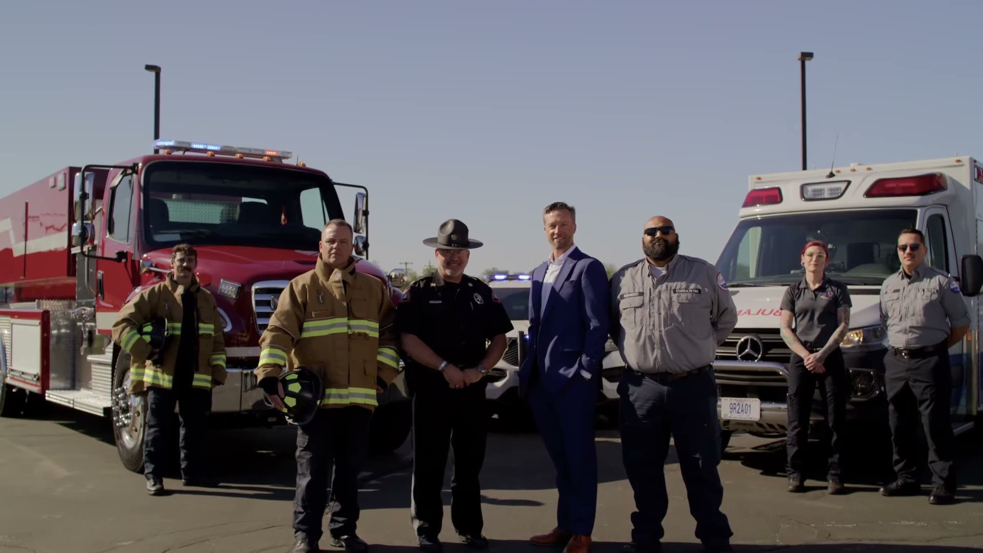 Lincoln Hough with firefighters, EMS and law enforcement in front of their trucks