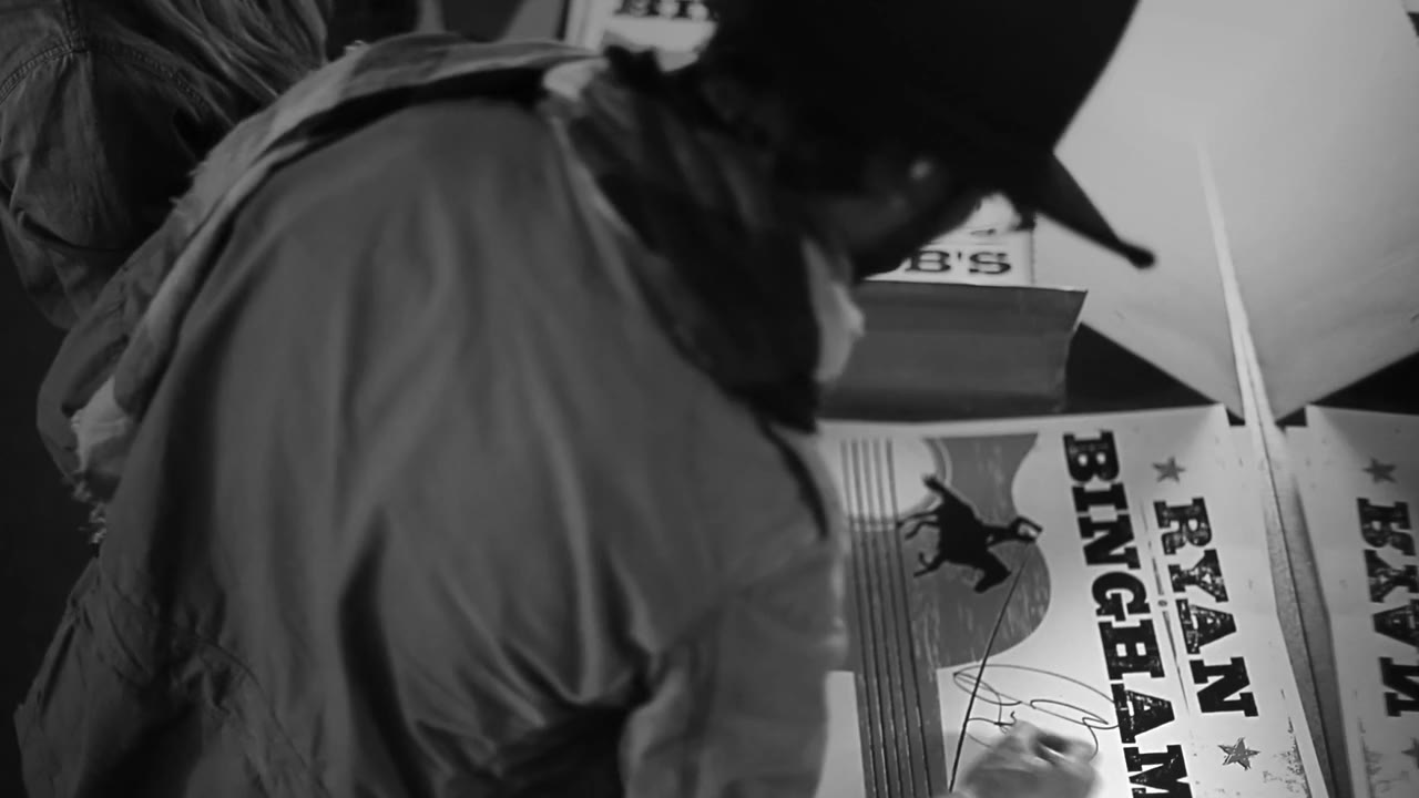 Ryan Bingham signing a tour poster backstage at Billy Bob's Texas