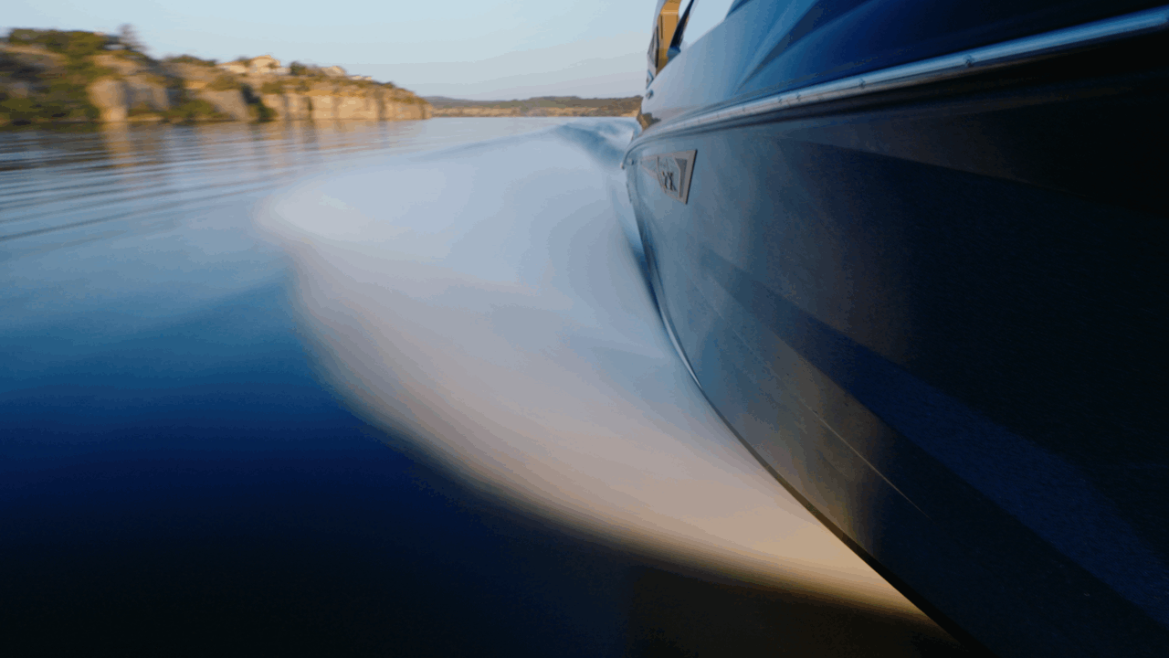 Side tracking shot of Tige boat at speed