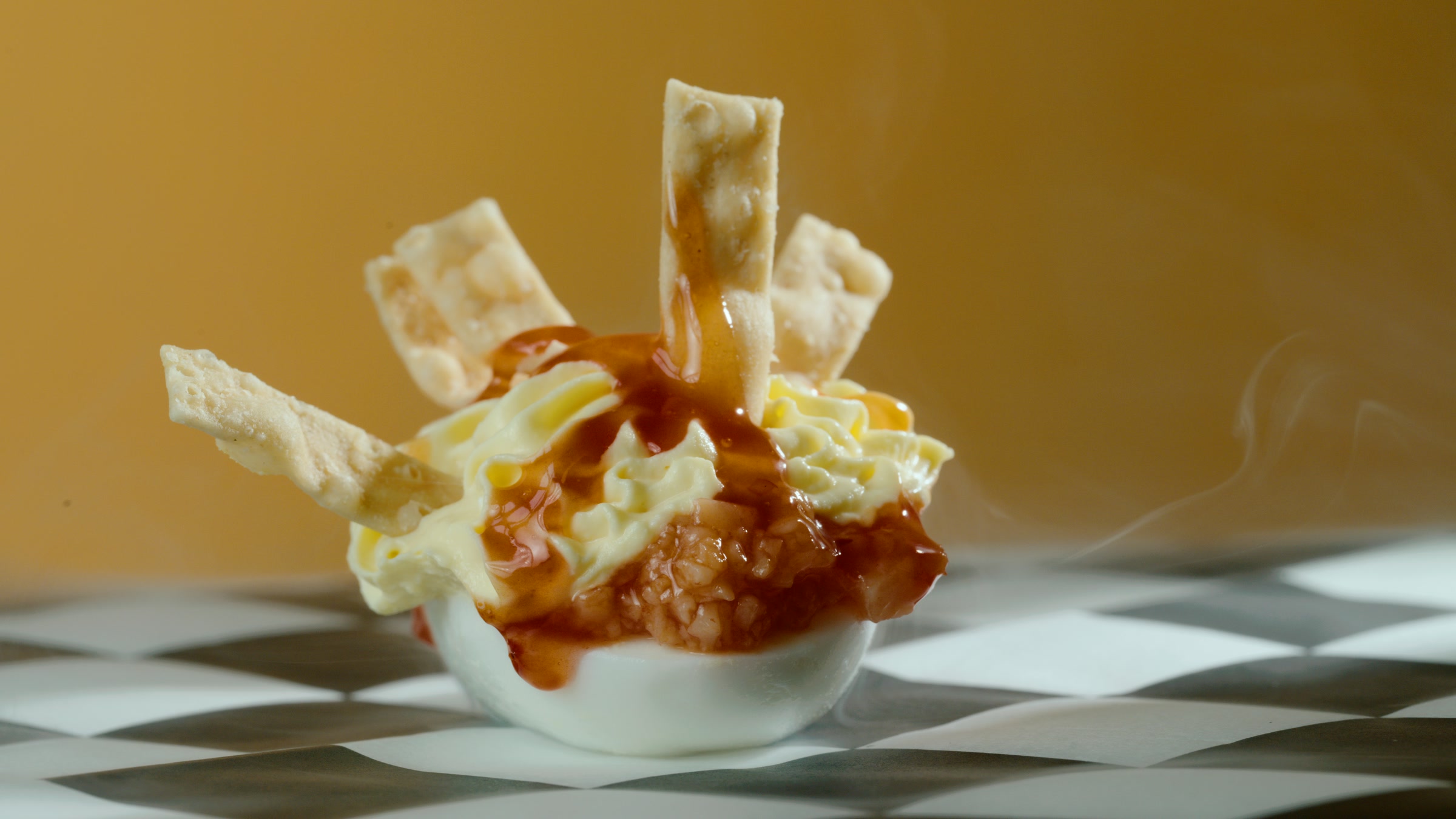 Crispy strip deviled egg hero with fried garnish and warm plated texture.