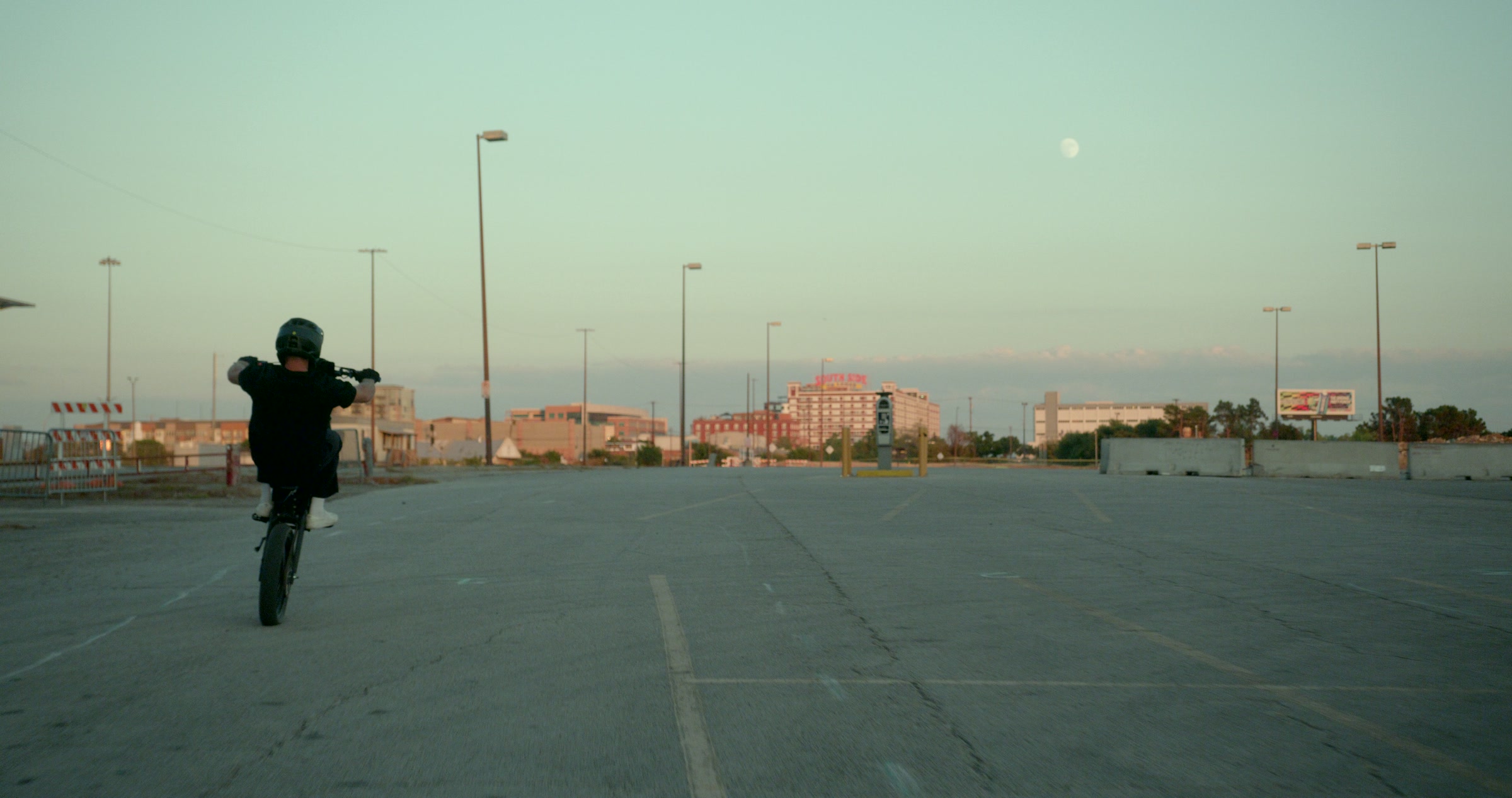 Still frame titled "Dusk Bridge Wheelie Wide" from the Filmsupply Factory Bike TV Construction Selects source drop.