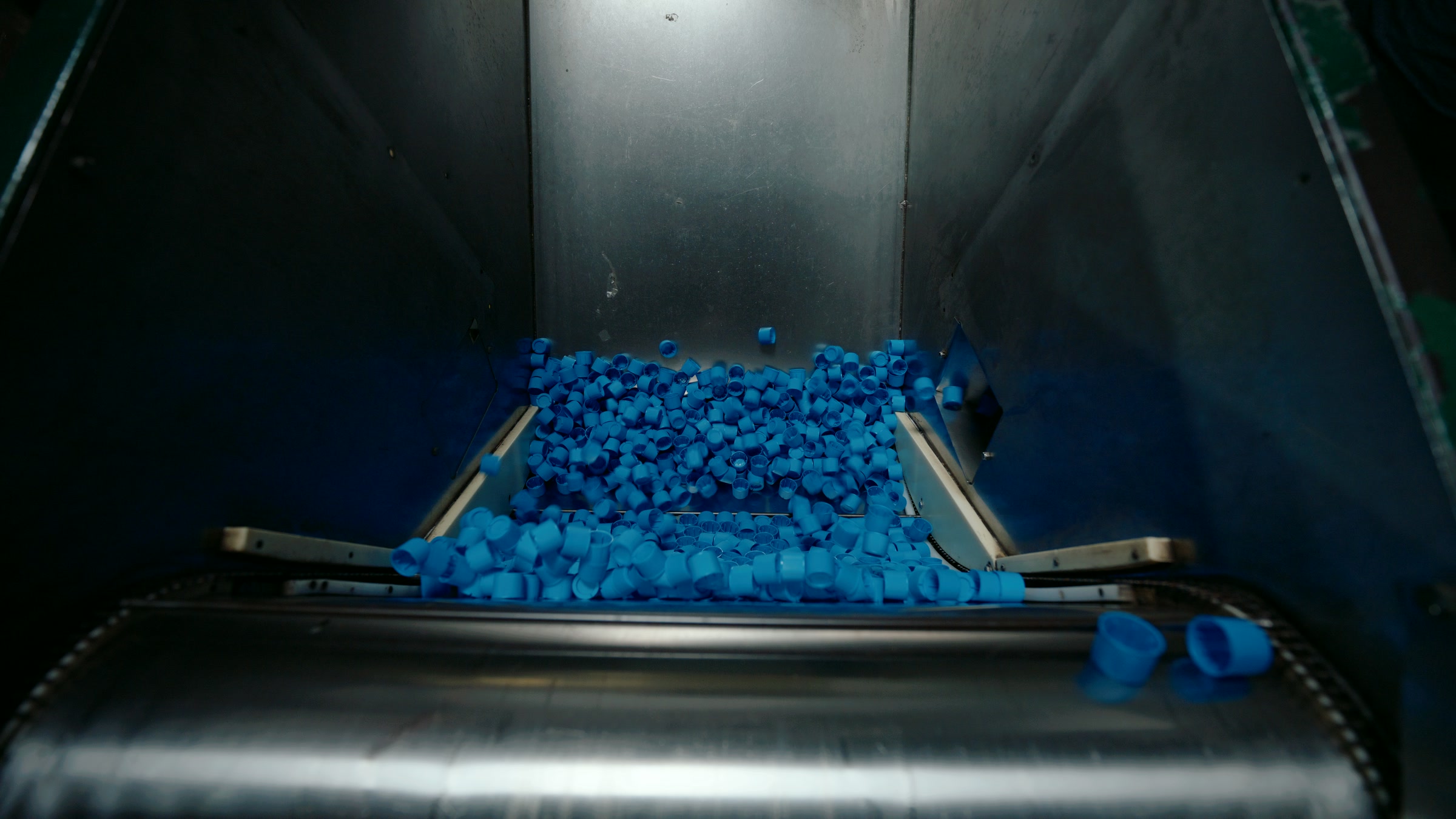 Still frame titled "Factory Blue Cap Conveyor Bin" from the Filmsupply Factory Bike TV Construction Selects source drop.