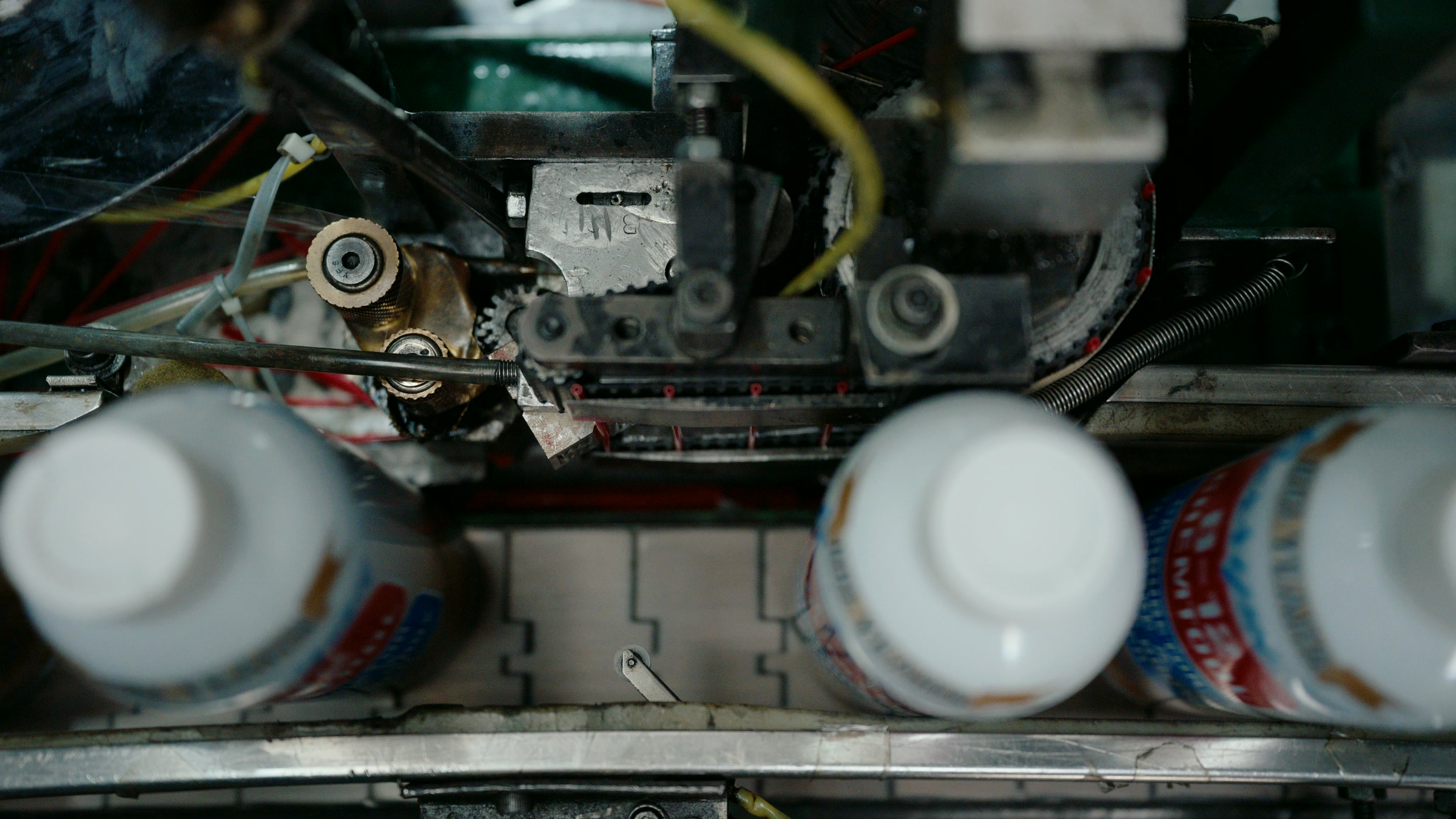 Still frame titled "Factory Mechanical Filling Head Detail" from the Filmsupply Factory Bike TV Construction Selects source drop.