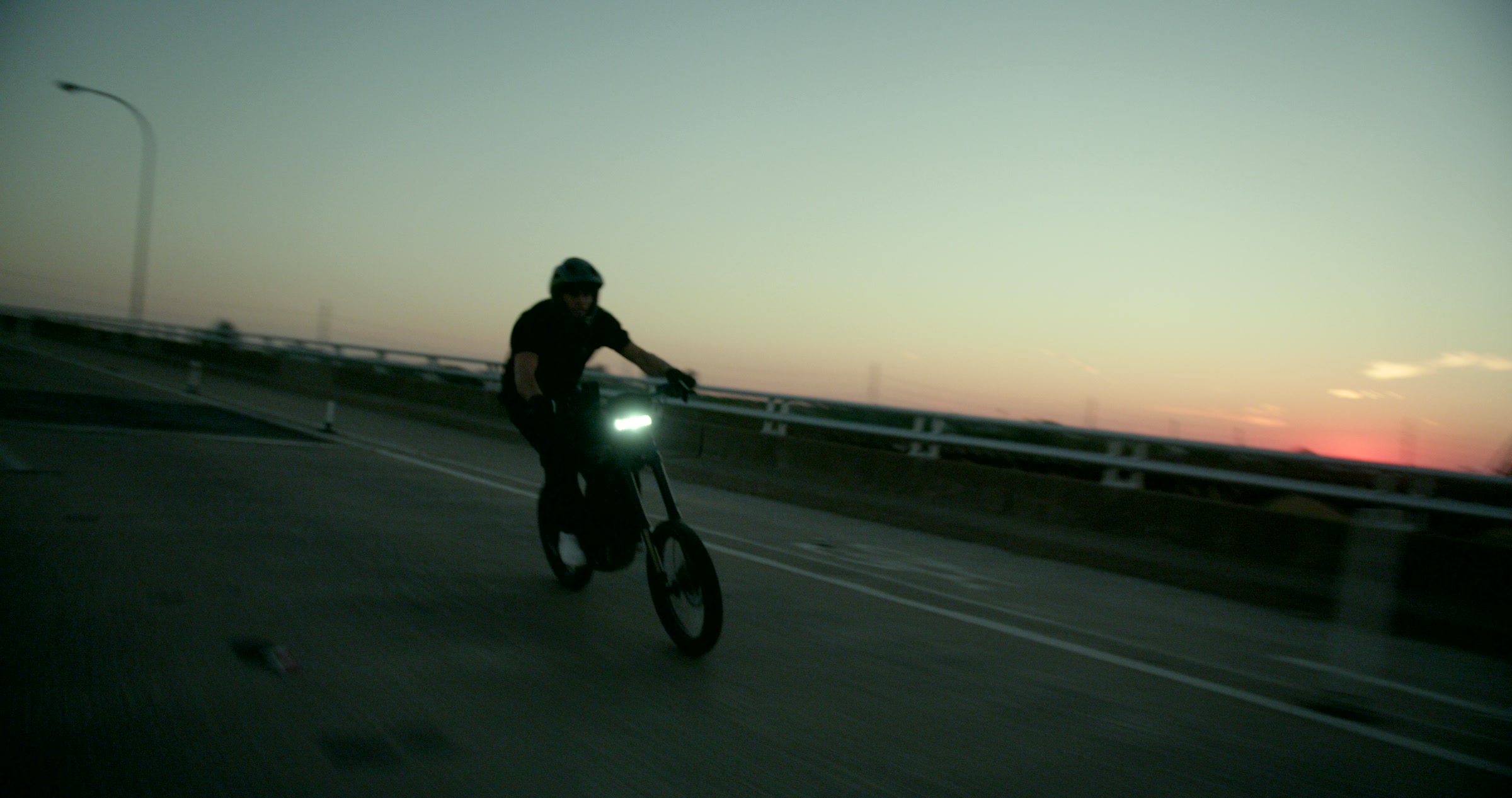 Still frame titled "Sunset Bike Silhouette Turn" from the Filmsupply Factory Bike TV Construction Selects source drop.