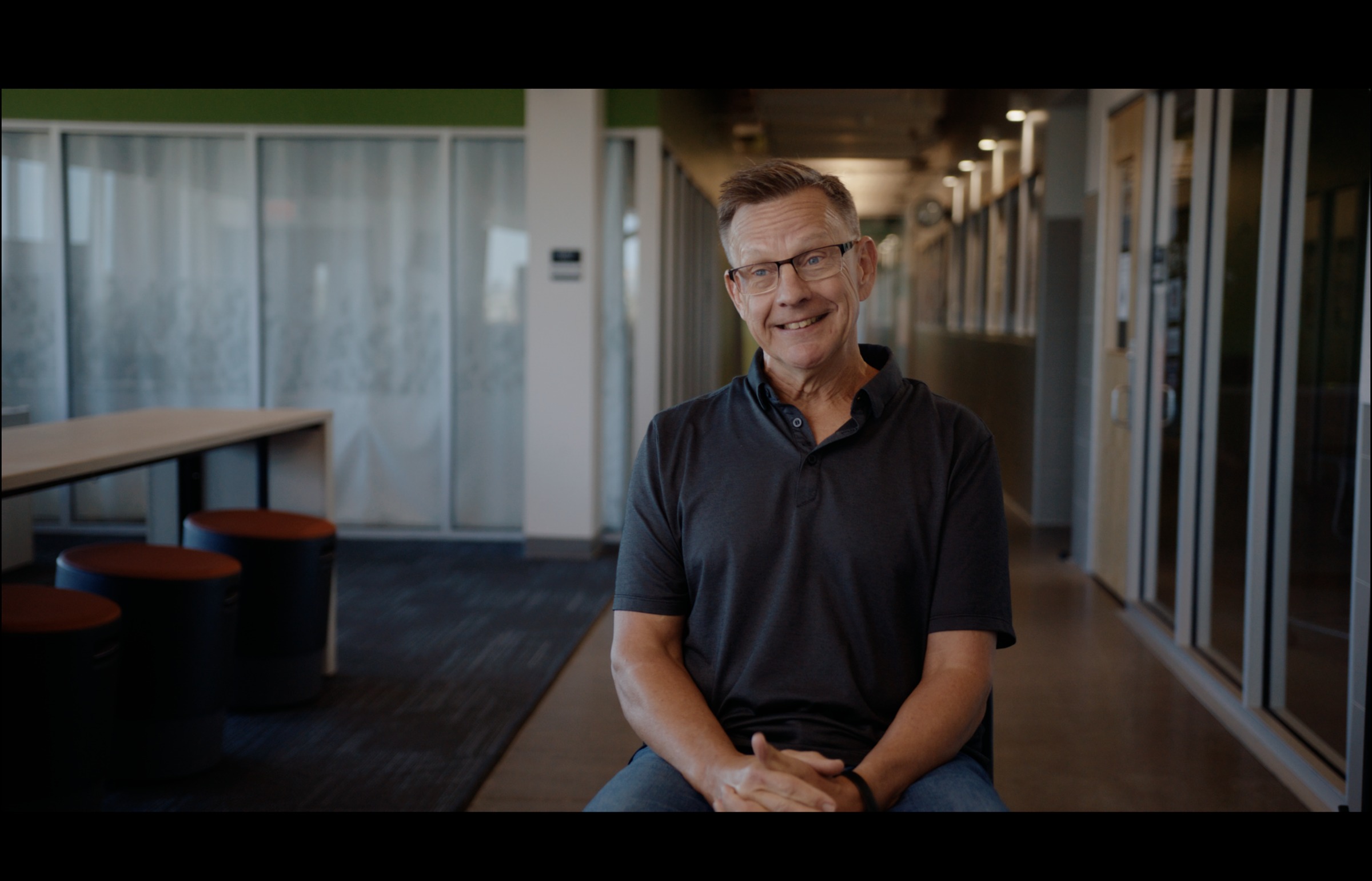 Still frame titled "High Ground Office Man Interview" from the GLM Filmsupply Frame Grab Titles source drop.