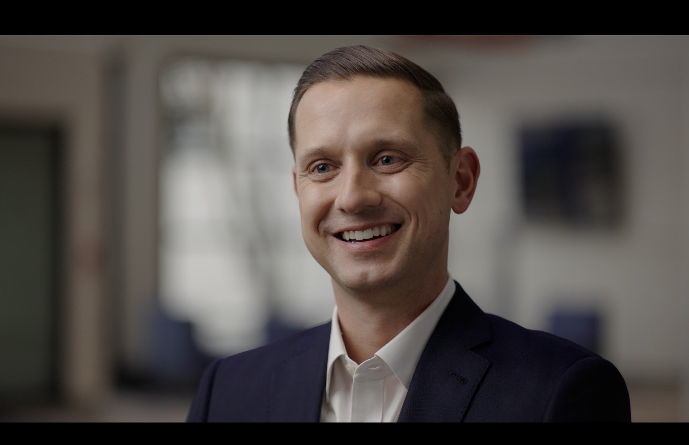 Still frame titled "Kindness Interview Three Quarter Smile" from the GLM Filmsupply Frame Grab Titles source drop.
