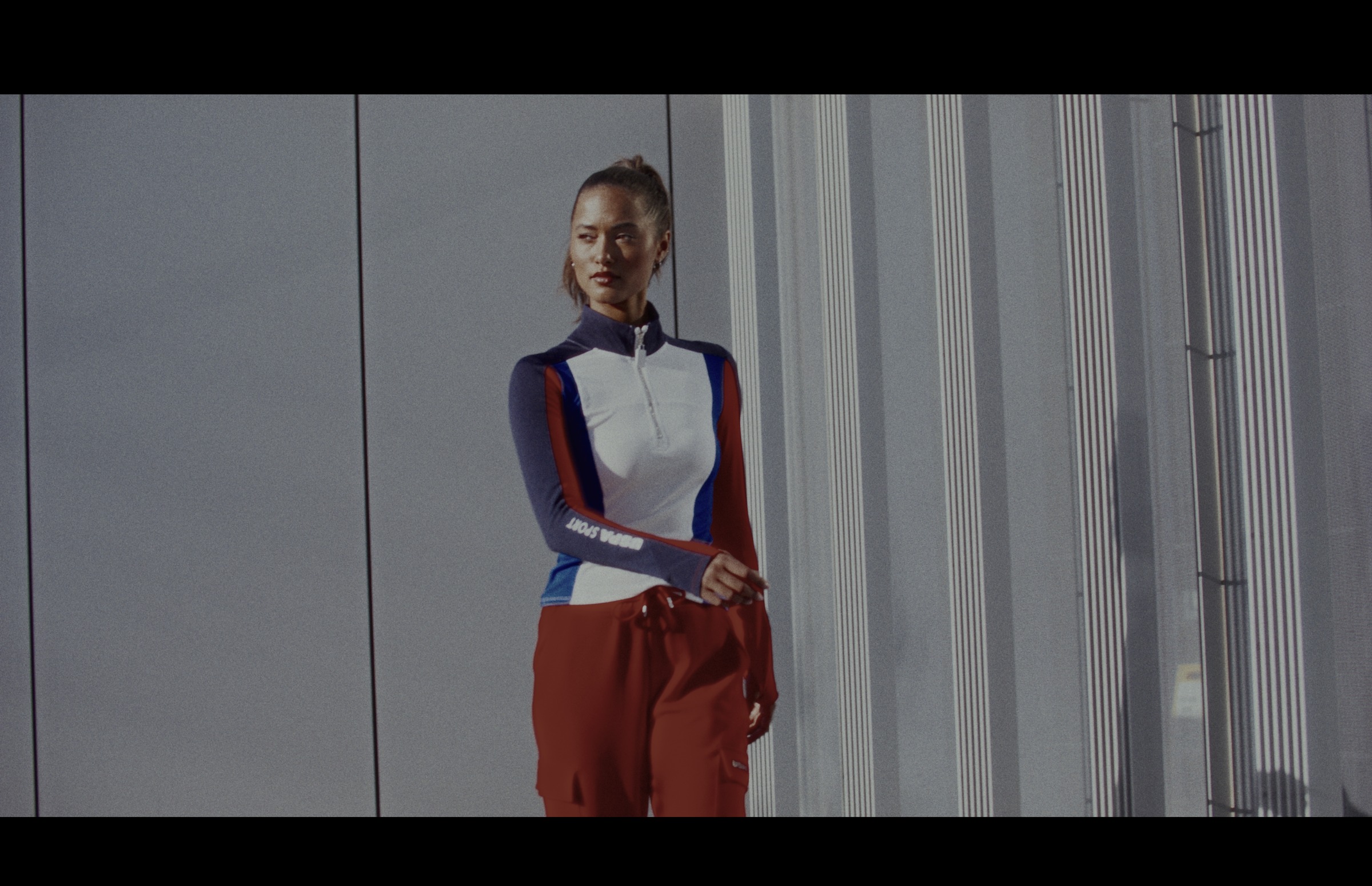 Still frame titled "Track Suit Standing Portrait" from the GLM Filmsupply Frame Grab Titles source drop.