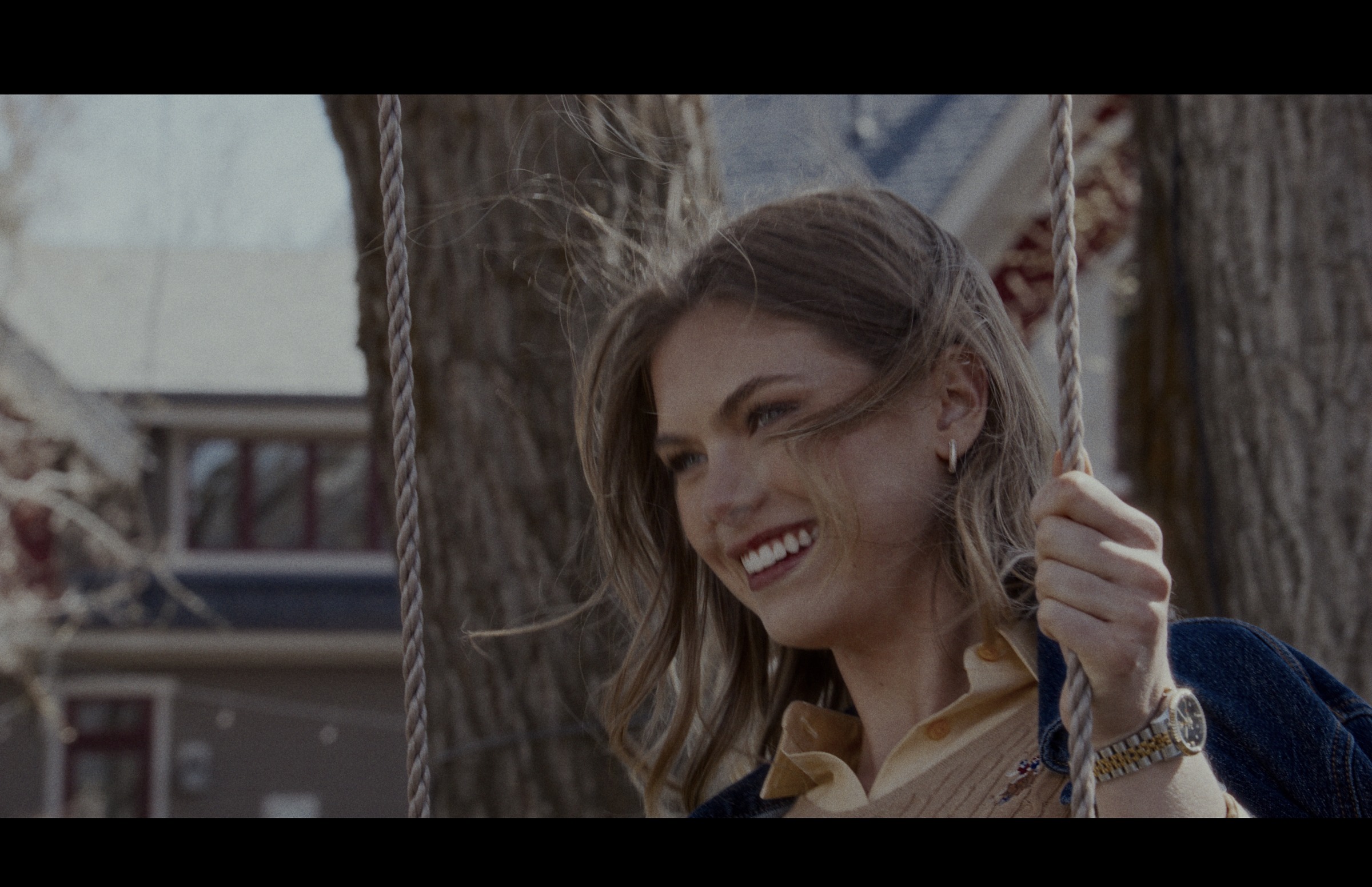 Still frame titled "Tree Swing Smile Portrait" from the GLM Filmsupply Frame Grab Titles source drop.