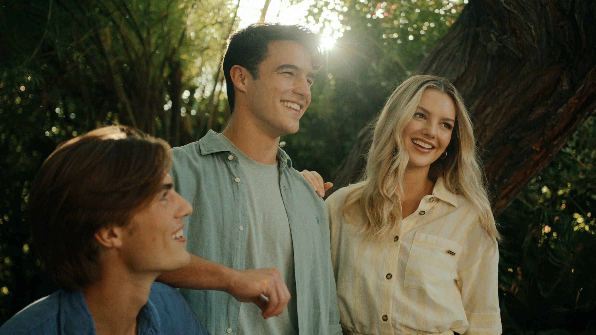 Garden group frame with warm backlight, relaxed wardrobe, and Palm Springs greenery.